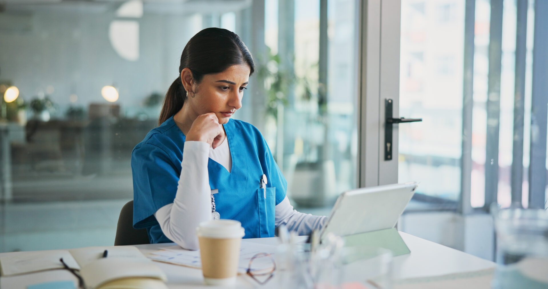 Nurse reviewing patient information digitally