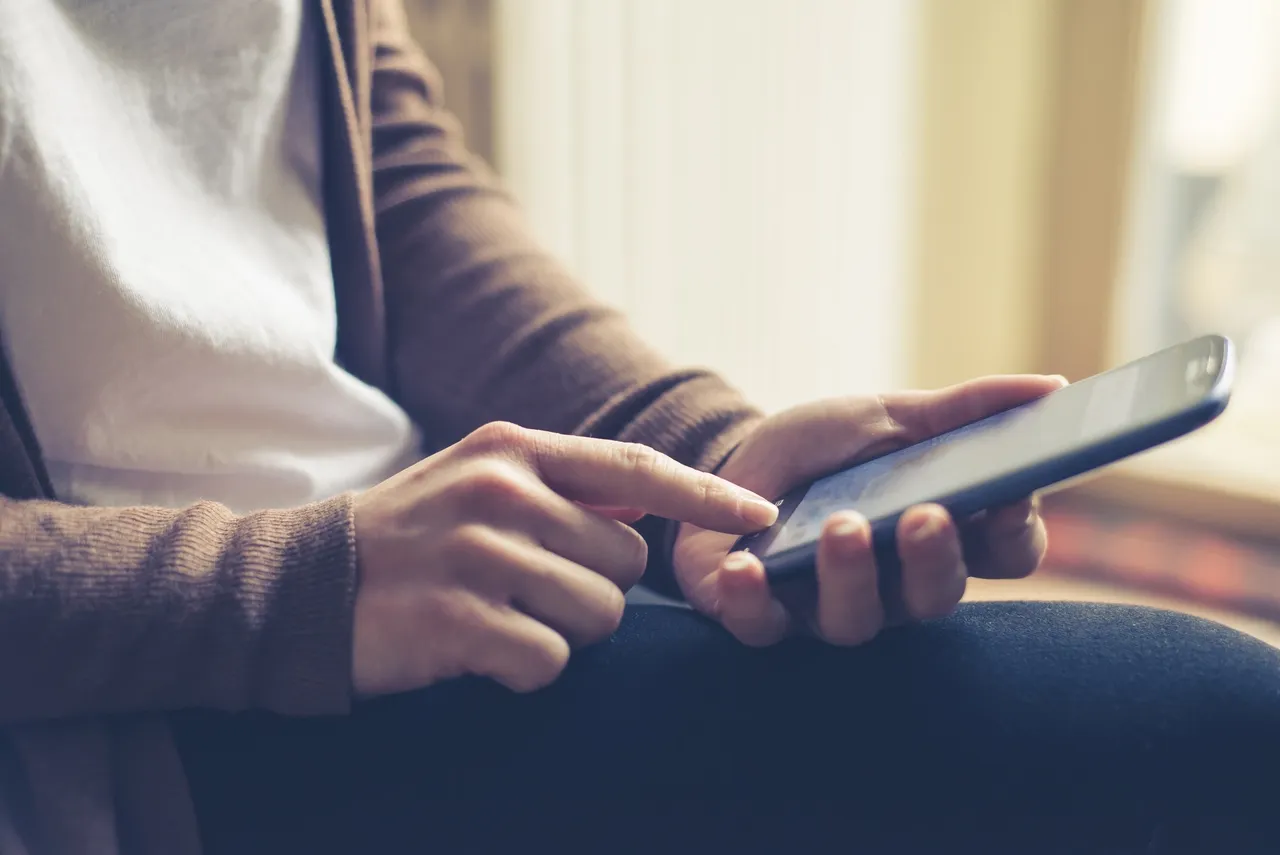 Hands holding a mobile phone