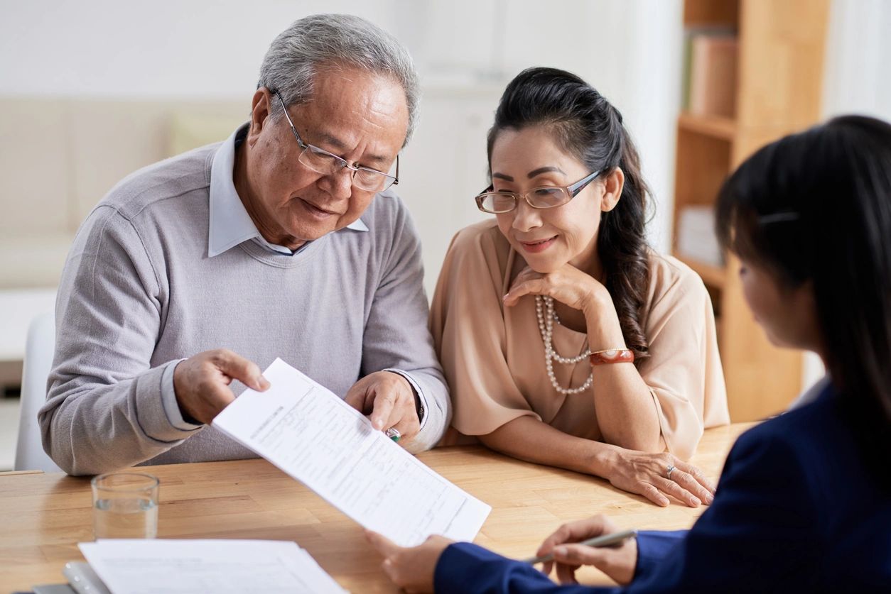 Senior couple discussing paperwork together