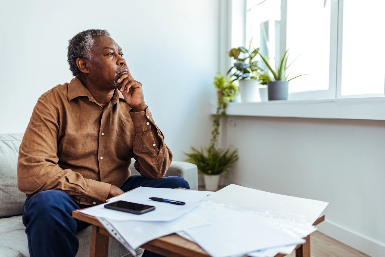 Man contemplating while sitting on couch